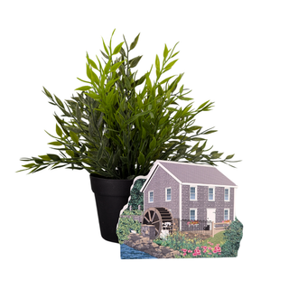 Potted plant with a 3/4" thick wooden replica of a gristmill and watermill on a white background