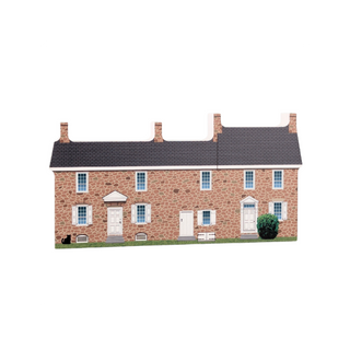 3/4" thick wooden cutout  of a brick house with white doors and windows on a white background