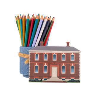 3/4" thick wooden cutout of  a brick building with colored pencil holder behind it