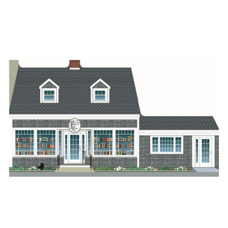 wooden replica with an Illustration of a two-story house with a sign that says 'the brewster book store' with  gray exterior and white trim.