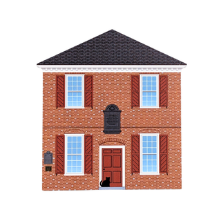 3/4" thick wooden replica with an illustration of a two-story brick house with brown shutters, white trim, a dark roof, a red-brown front door, and a small black cat standing at the doorway, shown on a plain white background.