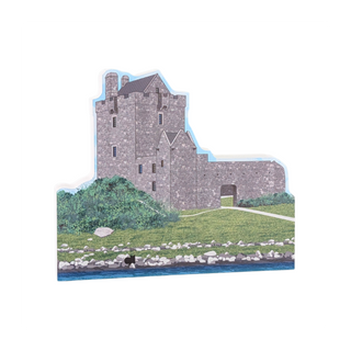 3/4" thick wooden cutout of a Stone castle with surrounding greenery and water on a white background