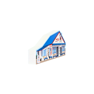 3/4" thick wooden replica with an illustration of a a blue roof, white walls, and multicolored storefront details, shown on a plain white background.