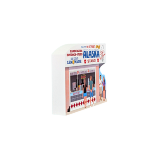 3/4" thick wooden replica with an illustration of a Alaska ice cream stand with colorful text and cartoon figures, shown on a plain white background.