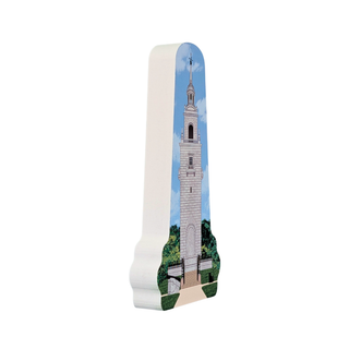 3/4" thick wooden replica with an illustration of a tall white tower with a blue sky and green trees, shown on a plain white background.