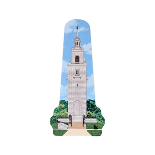 3/4" thick wooden replica with an illustration of a tall stone bell tower with green trees and a blue sky background, isolated on a white studio background.
