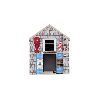 3/4" thick wooden replica with an illustration of a lobster restaurant building with gray shingled walls, a white-framed window, blue shutters, a red lobster sign, a black door, and an American flag on a white background.