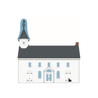 A wooden replica of a white brick house with a dark gray roof, a blue tower, and small black details, shown on a plain white background.