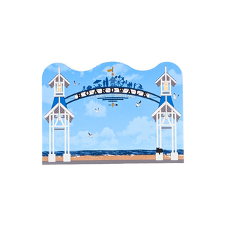 3/4" thick wooden replica with an illustration of the Boardwalk in Baltimore, Maryland, featuring a blue sky, white pier towers, beach, and birds, isolated on a white background.