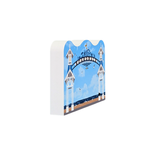 3/4" thick wooden replica with an illustration of a coastal archway scene with blue sky, white towers, and a dark blue banner reading 'BRIGHTON BY SEA', shown on a plain white background.