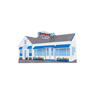 3/4" thick wooden replica with an illustration of a small ice cream shop building with white siding, blue awnings and trim, a gray roof, and a sign reading 'Home of the Ice Cream'.