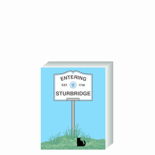 Wooden 3/4" Replica with a sign designating 'Entering Sturbridge' on a blue background