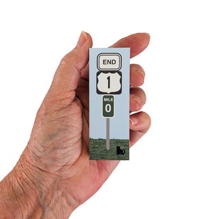 Hand holding a 3/4" thick wooden illustration of a sign