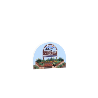 3/4" wooden replica with an illustration of a  sign with a garden design and text on a white background
