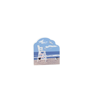 3/4" wooden replica with an illustration of a Lifeguard chair on a beach with a blue sky and white clouds.