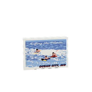 3/4" wooden replica with an illustration of people rafting in the ocean and text 'Rafting the Atlantic Ocean City, MD' on a white background.