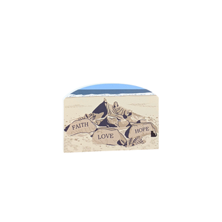 3/4" wooden replica with an illustration of a a sandcastle with 'Faith', 'Love', and 'Hope' text on a white background