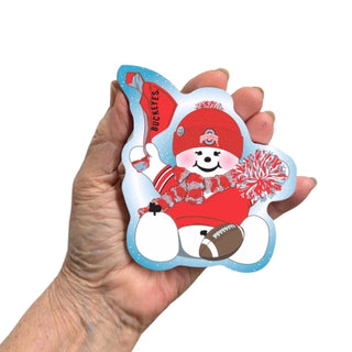 Hand holding a decorative wooden replica with a cartoon character wearing a red hat and holding a football, on a white background.
