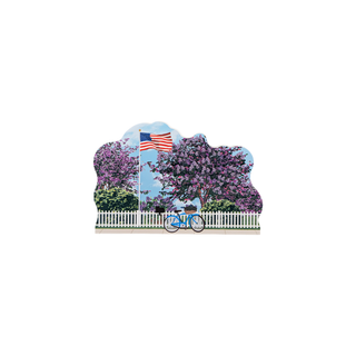 3/4" wooden replica with an illustration of a blue bike with an American flag surrounded by lilac trees 