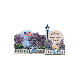 3/4" wooden replica with an illustration of a blue bike with an American flag surrounded by lilac trees and a sign that says welcome to mackinac island 