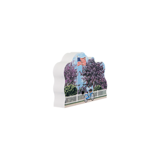 3/4" wooden replica with an illustration of a blue bike with an American flag surrounded by lilac trees 