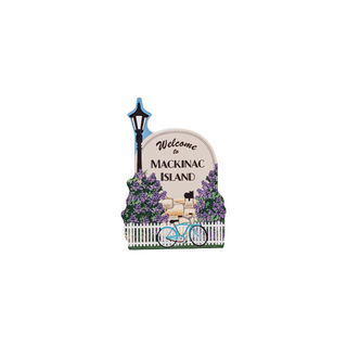 3/4" wooden replica with an illustration   with 'Welcome to Mackinac Island' text, bicycle, and lamp post design on a white background.