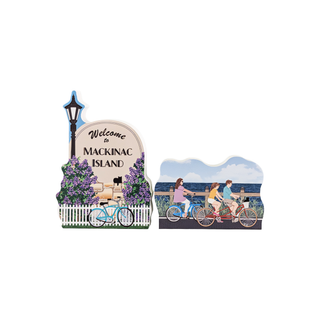 Two decorative wooden replicas featuring a scenic view of Mackinac Island with bicycles and people.