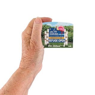 Hand holding a 3/4" thick wooden illustration of a refuge sign on a white background
