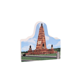 3/4" thick wooden  cutout of a brick monument with a scenic background