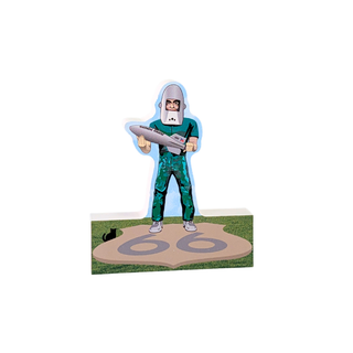 3/4" thick wood model of a person in a green jumpsuit with a helmet, holding a device, on a grassy area with '66' marking.