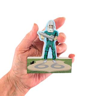 Hand holding a 3/4" thick wood model with a cartoon character on a white background
