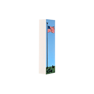 3/4" thick wooden replica with an illustration of an American flag flying on a flagpole against a clear blue sky, with a small patch of green grass at the bottom. The print is shown at a slight angle with a white side edge, isolated on a white background.