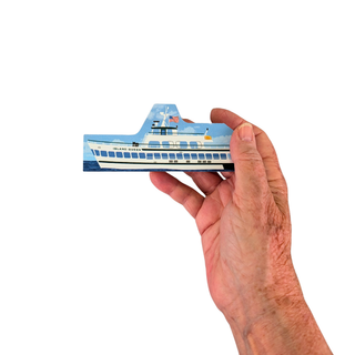 A hand holding a small 3/4" thick wooden replica with an illustration of a boat model against a plain white background.