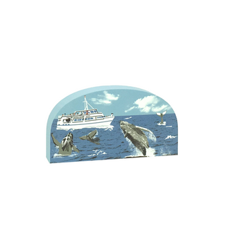 wooden replica with an Illustration of a boat with whales in the ocean 