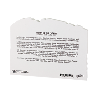 Back of a 3/4" thick wooden figurine with text about Alaska's state motto and history.