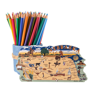 Colorful pencils with a 3/4" thick wooden Nebraska-shaped map on a white background