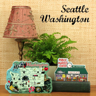 Decorative items including a lamp, plant, and signs with 'Seattle Washington' text on a wooden surface.