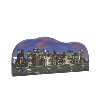 3/4" thick wooden cutout  of a City skyline silhouette with illuminated buildings against a dark blue sky.