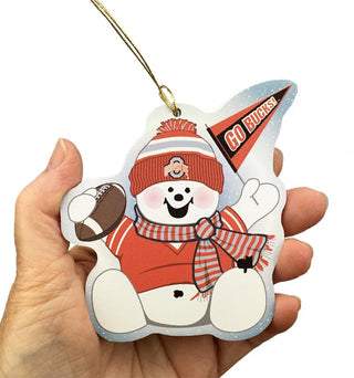 Decorative ornament shaped like a snowman with sports-themed design, held in a hand.