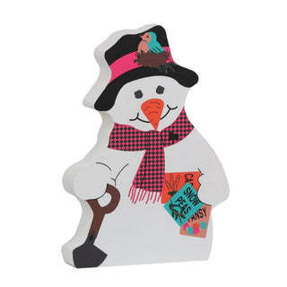 3/4" thick wooden replica with an Illustration of a white snowman with a black hat, pink and black checkered scarf, orange carrot nose, and a small bird on the hat, holding a sign that reads 'COLD SNOW PEASY FANSY'.