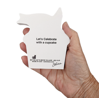Hand holding a cupcake shaped wooden replica cupcake holder with text on a white background