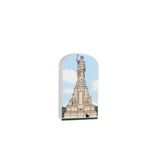 3/4" wooden replica with an illustration of a Statue of a woman on an arch with a blue sky background