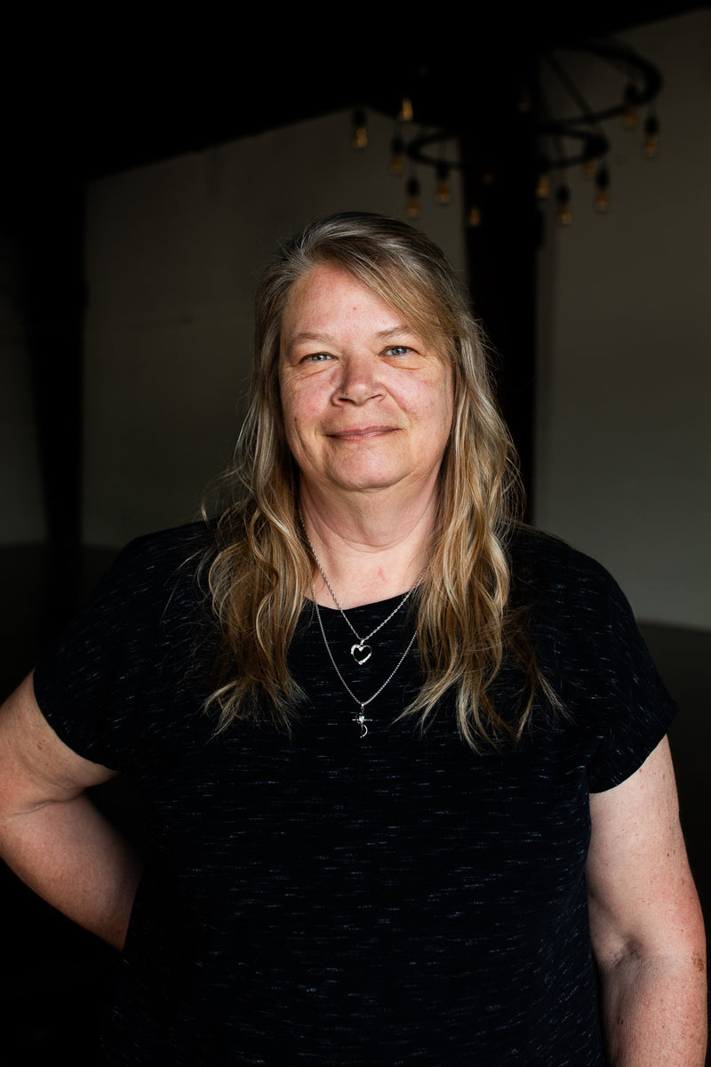Woman wearing a black shirt with a dark background