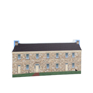 3/4" thick wooden cutout of a Stone building with a black roof on a white background