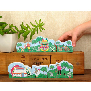 Set of colorful illustrated stickers depicting farm scenes on a wooden box.