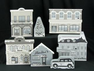 Set of decorative building models with various facades on a black background