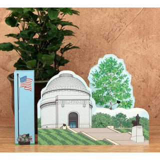 3/4" thick wooden cutout  of a building with trees and a flag on a wooden surface