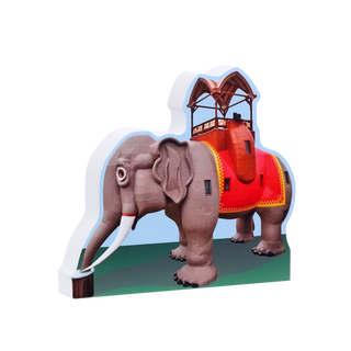 3/4" thick wooden illustration of an elephant with a colorful saddle on a white background