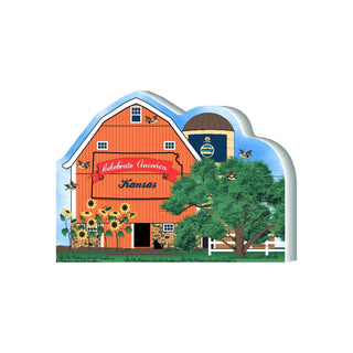 3/4" thick wooden model of a red barn, sunflowers, and trees, featuring 'Celebrate America Kansas' text.