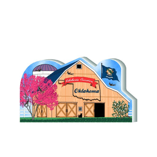3/4" thick wooden cutout Wooden barn with 'Celebrate America Oklahoma' text, pink tree, and blue sky.